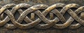 A bronze textured surface with intricate, Celtic knotwork patterns engraved into the metal, adding Royalty Free Stock Photo