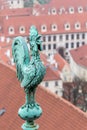 Bronze weathercock at the roof of st vitus cathedral