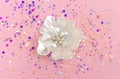 Brooch flower with pearls in spangles isolated on pink background