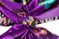 Brooch with stones on silk purple scarf Royalty Free Stock Photo