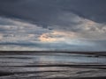 Brooding storm clouds and heavy rain on a beach in northumbria