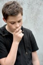 Brooding teenage boy outside Royalty Free Stock Photo