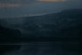 Brooding view of Wayoh reservoir in the mist at dusk Royalty Free Stock Photo