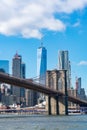 The Brooklyn Bridge with an American Flag over the East River with the Lower Manhattan New York City Skyline Royalty Free Stock Photo