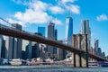 The Brooklyn Bridge with an American Flag over the East River with the Lower Manhattan New York City Skyline Royalty Free Stock Photo