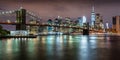 Brooklyn Bridge and the Financial District`s skyscrapers at twilight with light clouds. New York City Royalty Free Stock Photo