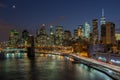 Brooklyn Bridge with lower Manhattan skyline in New York City at night. Royalty Free Stock Photo