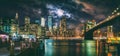 New York City Brooklyn Bridge and Manhattan skyline illuminated at night with full moon overhead. Royalty Free Stock Photo