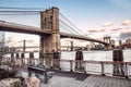 Brooklyn Bridge and Manhattan bridge view with New York City skyline from East River promenade.