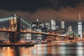 Brooklyn bridge and New York City Manhattan downtown skyline at dusk with skyscrapers illuminated over East River Royalty Free Stock Photo