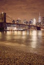 Brooklyn Bridge and New York City skyline at night, color toning applied, USA Royalty Free Stock Photo