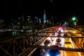 Brooklyn bridge in New York at night with cars passing Royalty Free Stock Photo