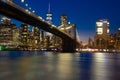 Brooklyn bridge at night with water reflection