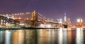 Brooklyn Bridge over East River at night in New York City Manhattan with lights and reflections. Royalty Free Stock Photo