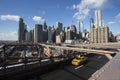 The Brooklyn bridge and a yellow cab Royalty Free Stock Photo