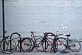 Brooklyn, New York: A group of bicycles chained to sign posts and curbside bike stands on an urban sidewalk Royalty Free Stock Photo
