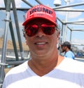 President Donal Trump supporter wears famous red hat with sign Trump Keep America Great 2020