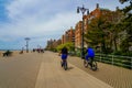 Pedestrians and bicyclists enjoy outdoor during COVID-19 pandemic on the Riegelmann boardwalk at Coney Island Beach in Brooklyn