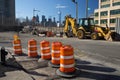 Brooklyn, New York - USA - July 10 2016: Construction site with orange cones and backhoe with world trade center and new york skyl