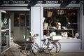 Brooklyn, NY - April 23 2021: Bike with basket plants and decoration in front of the entrance of store. Vintage exterior look of