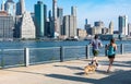 BROOKLYN, NY - AUGUST 27 2020: A couple and their dog run on Pier 3 in Brooklyn Bridge Park Royalty Free Stock Photo