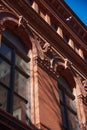 The red brick and terra cotta facade of the Brooklyn Historical Society 1881, with arched windows, sculptured heads and cornices