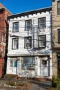 White three-story wood frame house in the Vinegar Hill neighborhood of Brooklyn