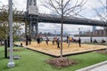 Brooklyn, NY - USA - April 17, 2021: A view of people enjoying a game of volley ball at Domino Park`s Beach Volleyball court. A