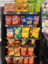 Display of various Lays, Doritos, Cheetos and Fritos potato chips and snacks sale at a