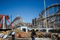 A construction crew works outside near Luna Park in Coney Island amusement park on a spring day