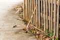 Broom against the wooden fence, home fence, background texture.