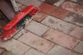 Broom and dustpan on a stone tiled floor in the courtyard Royalty Free Stock Photo