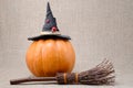 Broom and hat of witch on a pumpkin for Halloween Royalty Free Stock Photo