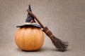 Broom and hat of witch on a pumpkin for Halloween Royalty Free Stock Photo