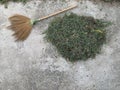 Broom and haystack on cement floor