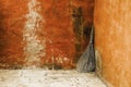 Broom leaning against the wall in a rural courtyard