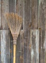 The broom is placed on an old wooden wall in rural area Royalty Free Stock Photo