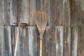 The broom is placed on an old wooden wall in rural area Royalty Free Stock Photo