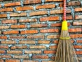 Broom sticks hung on brick walls Royalty Free Stock Photo