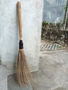broom sticks from old coconut leaf bones with handmade bamboo stalks are still in demand today Royalty Free Stock Photo