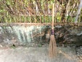 broom sticks from old coconut leaf bones with handmade bamboo stalks are still in demand todaybroom stick Royalty Free Stock Photo