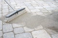 Broom Sweeping Sand into Pavers Royalty Free Stock Photo