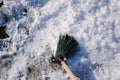 Broom for sweeping snow. Sweep snow with a broomstick.