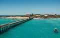 Long pier leading to port of Broome, Australia.