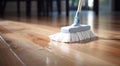 brooming a hardwood floor with white broom