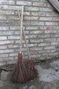Brooms of branches on the brick wall background Royalty Free Stock Photo