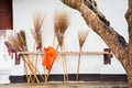 Brooms in the courtyard of the temple Wat Sensoukaram in Louangphabang, Laos. Close-up.