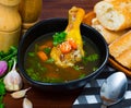 Broth with chicken leg in black bowl Royalty Free Stock Photo