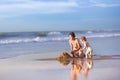 Brother and baby sister building a sand castle