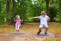 Brother and baby sister on swing on playground Royalty Free Stock Photo